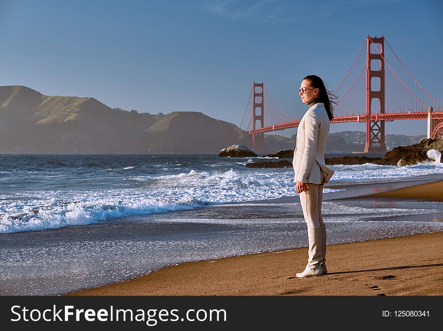 Woman on Baker Beach near Golden Gate Bridge in San Francisco, California, USA. Woman on Baker Beach near Golden Gate Bridge in San Francisco, California, USA