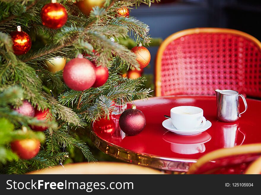 Outdoor Parisian cafe with beautiful Christmas tree decorated for season holidays