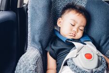 Asian Baby Boy Travel In Car Seat And Sleeping Stock Images