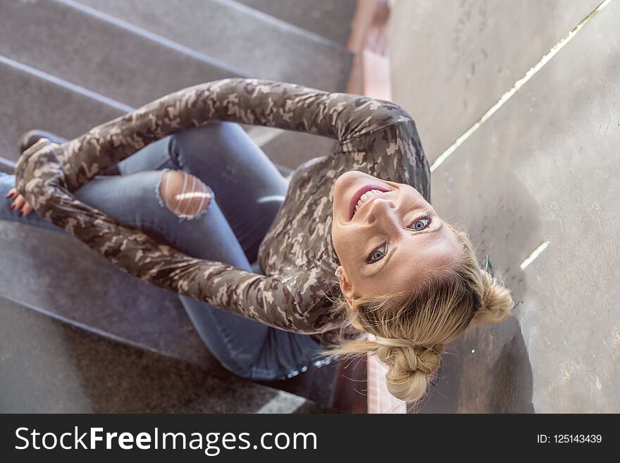 Blonde Girl Sitting On Stairs