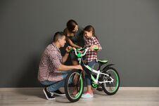 Portrait Of Parents And Their Daughter With Bicycle Stock Photos