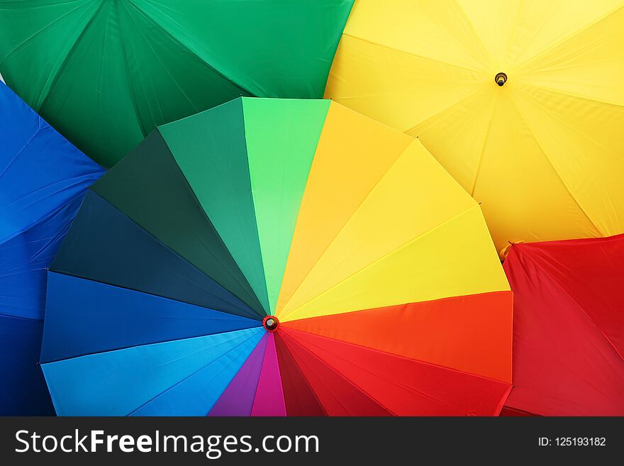 Many stylish colorful umbrellas as background, closeup