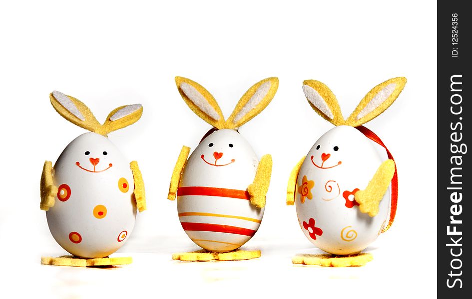 Easter eggs painted like bunnies on white