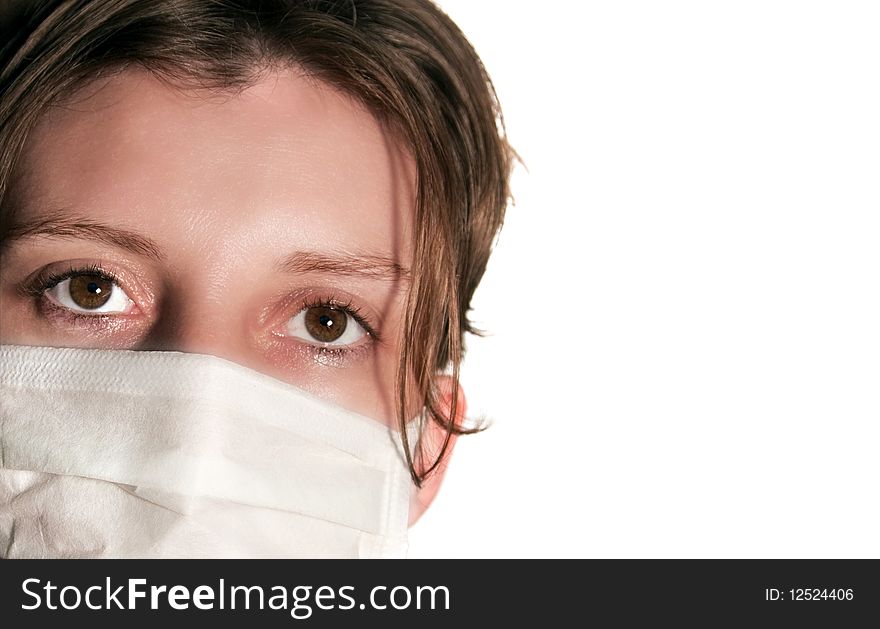 Woman with big green eyes wearing medical mask