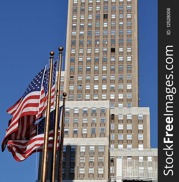 Exterior of modern skyscraper building with American flags in foreground, New York City, U.S.A. Exterior of modern skyscraper building with American flags in foreground, New York City, U.S.A.