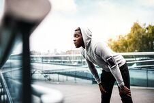 Young Sporty Black Man Runner With Smartphone On The Bridge In A City, Resting. Stock Photography