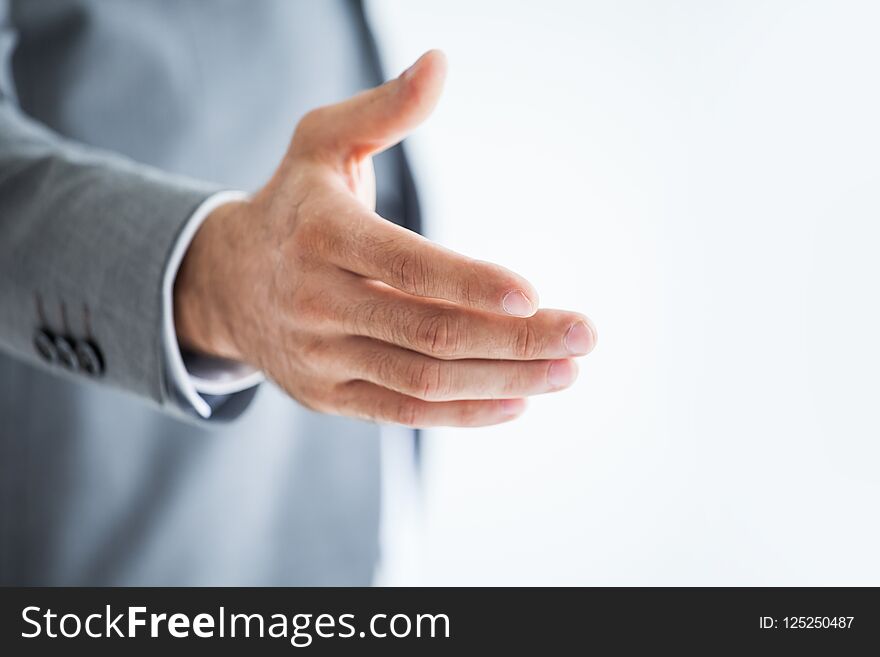 businessman extending hand to shake on white background