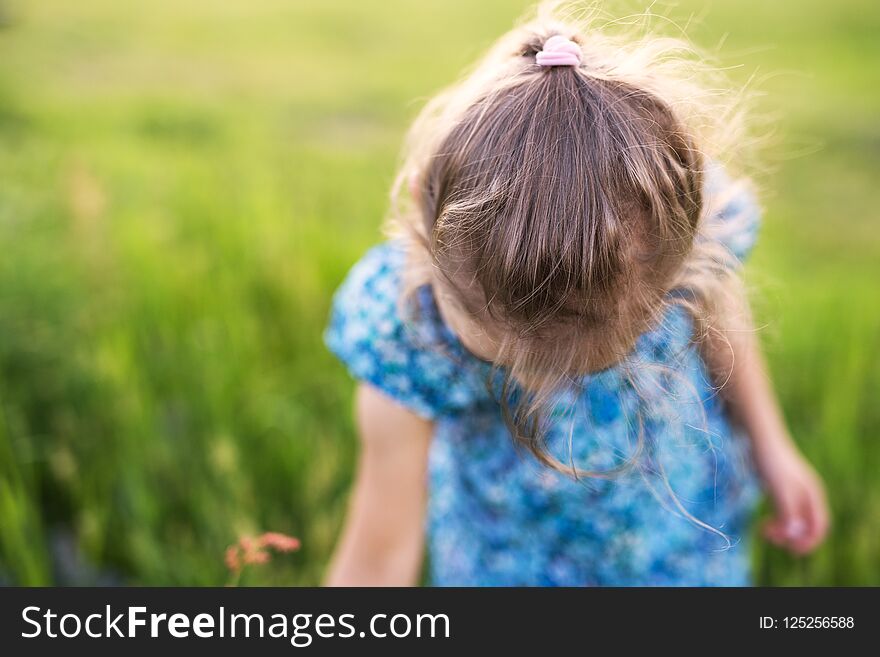 A small girl in the garden in spring nature. Close up.