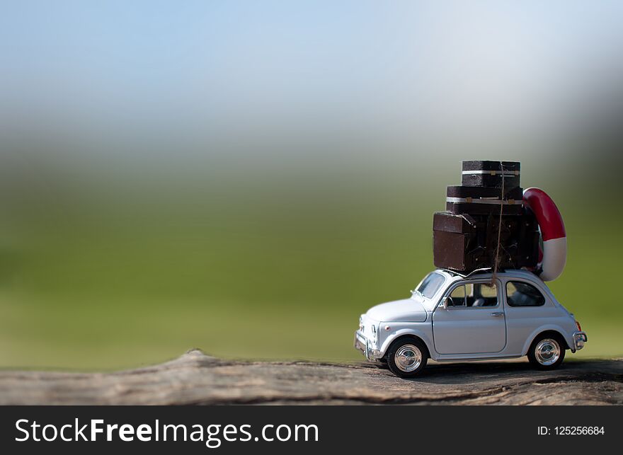 Miniature car with suitcases in the countryside. Miniature car with suitcases in the countryside