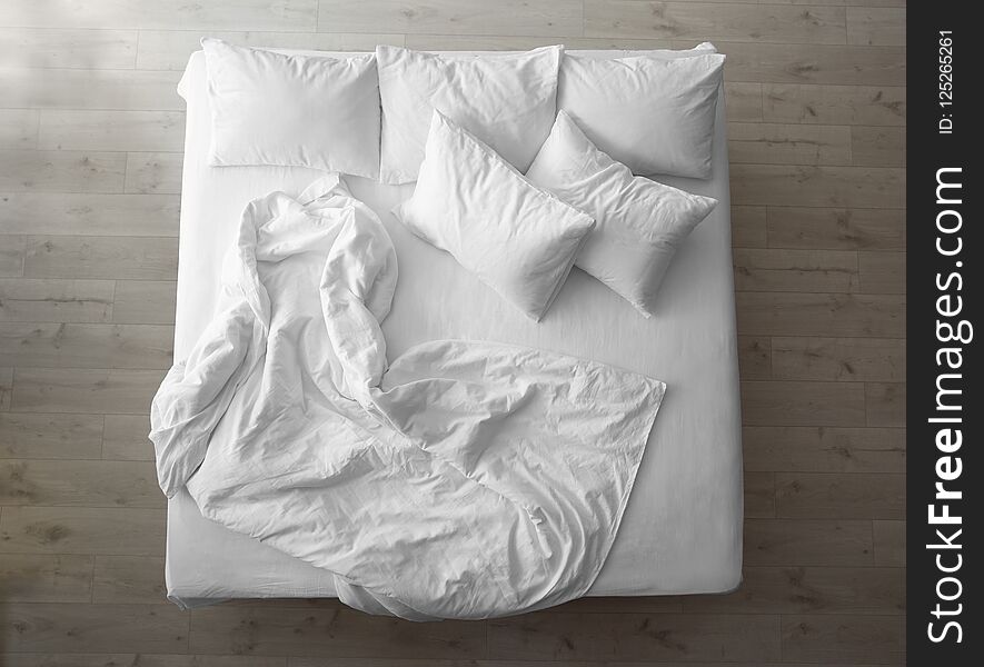 Comfortable bed with soft pillows indoors