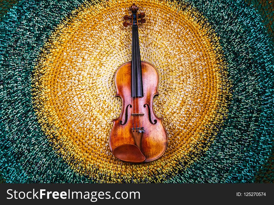 violin on a colored knitted rug