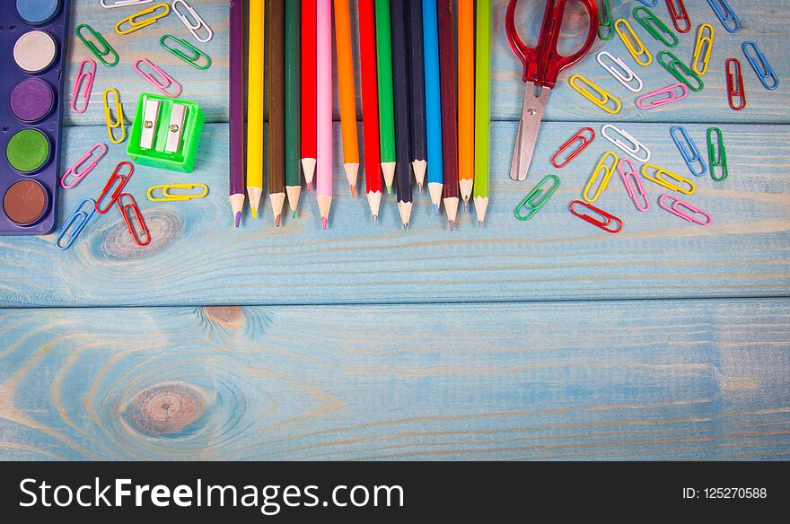 School supplies on a blue wooden background. A place for an inscription. Back to school. School supplies on a blue wooden background. A place for an inscription. Back to school.