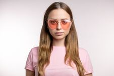 Stylish Fair-haired Woman Looking Through Pink Sunglasses To The Camera Royalty Free Stock Photography Stylish Fair-haired Woman Looking Through Pink Sunglasses To The Camera Royalty Free Stock Photography