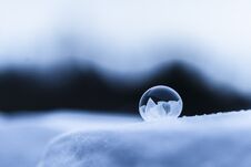 Frozen Round Soap Bubble On Snow Royalty Free Stock Photos