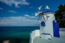 Traditional Greek White Windmill On The Sea Shore On A Bright Sunny Day Royalty Free Stock Photos