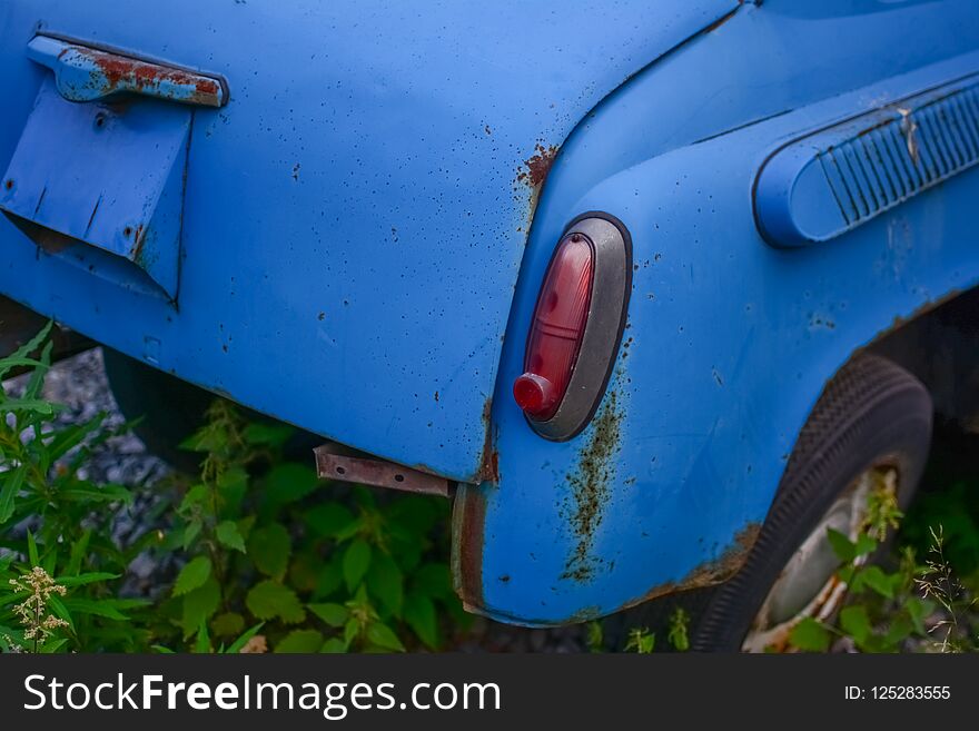 Raear part of bright blue old automobile with htadlights. Raear part of bright blue old automobile with htadlights