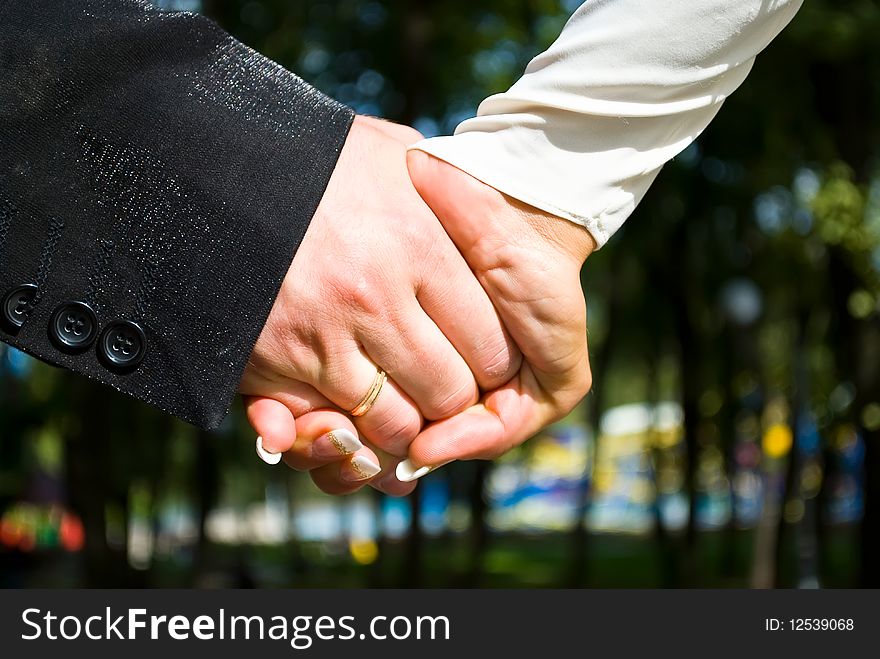 Hands of newlyweds or just married include wedding ring