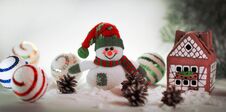 Toy Snowman And A Gingerbread House On A Light Background. Stock Photography