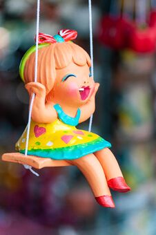 A Ceramic Doll On A Swing Stock Photo