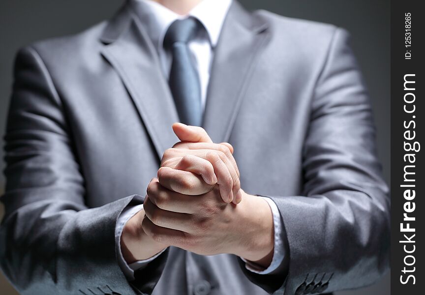 Close Up.businessman Shows A Sign With His Hands. On Black Background