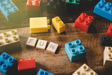 Plastic Toy Bricks With Alphabet Tiles Word FUN On Wooden Table Royalty Free Stock Image