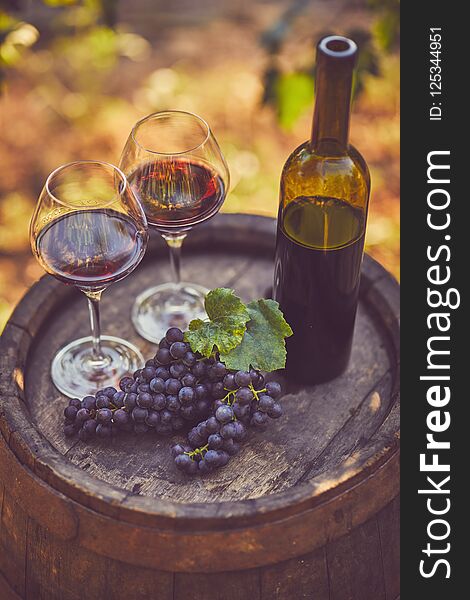 Top view of two glasses of red wine on a wooden barrel