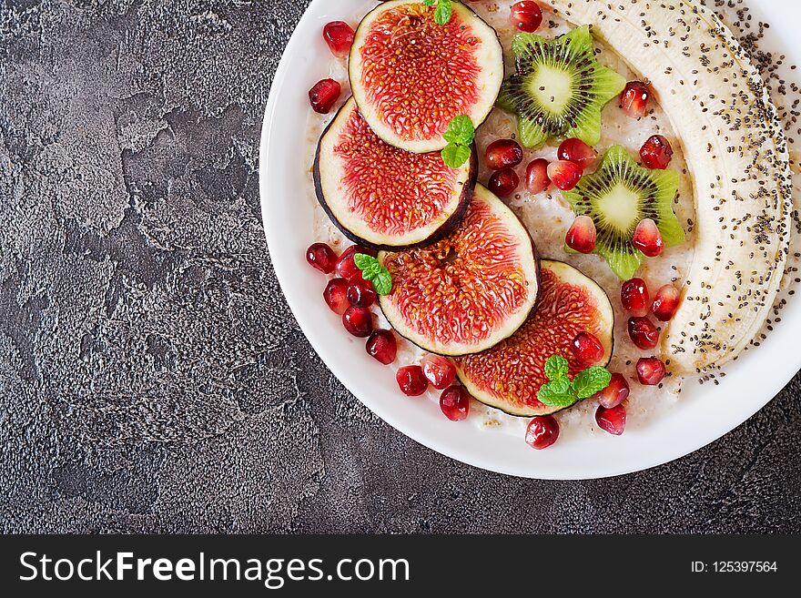 Delicious and healthy oatmeal with figs, kiwi, pomegranate, banana and chia