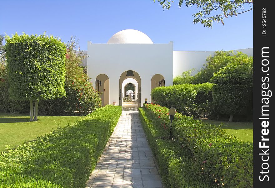 Beautiful garden at hotel resort and building in traditional arabic style. Beautiful garden at hotel resort and building in traditional arabic style