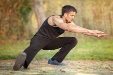 Young Fitness Man Runner Stretching Legs Before Running Stock Images