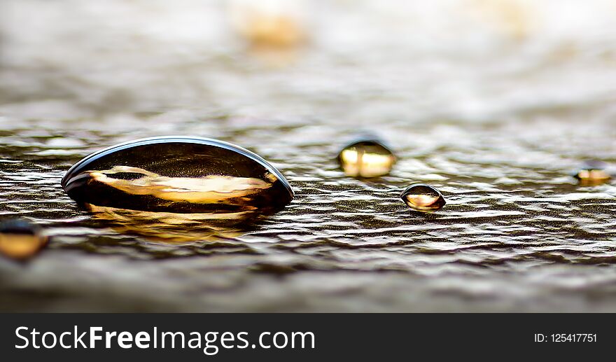 Gold Water drops closeup on silver foil background closeup macro