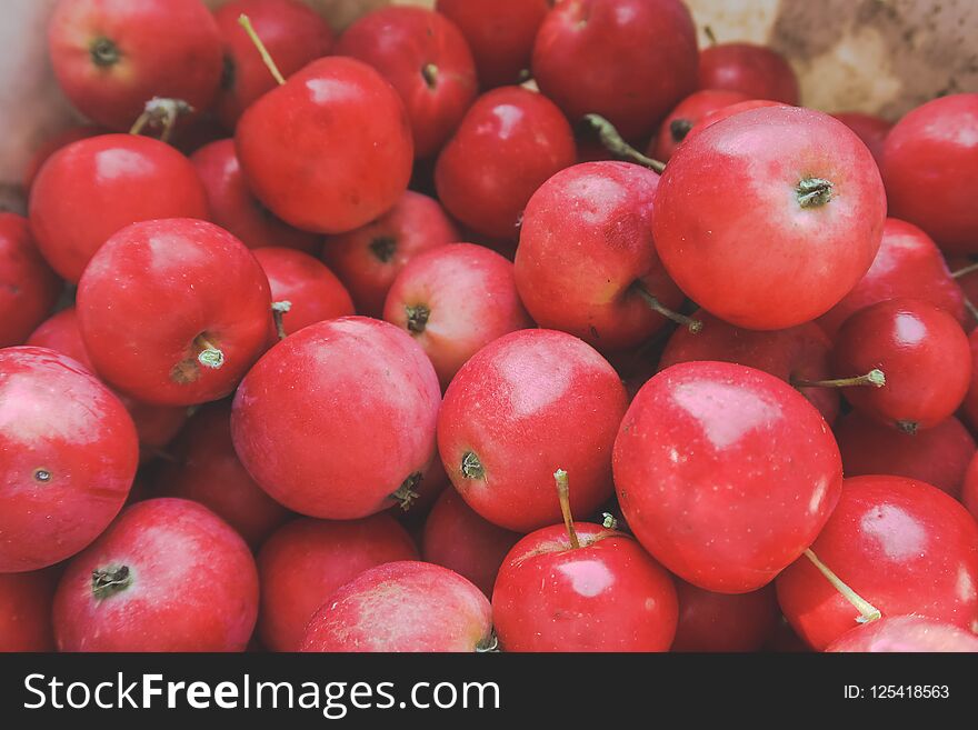 Red apples with leaves on the table. Texture of fruits.