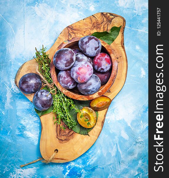 Plums on wooden table close-up. Healthy diet