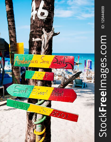 Phuket colourful beach sign at Patong beach, summer tropical island white sand beach with sign and coconut tree, Thailand