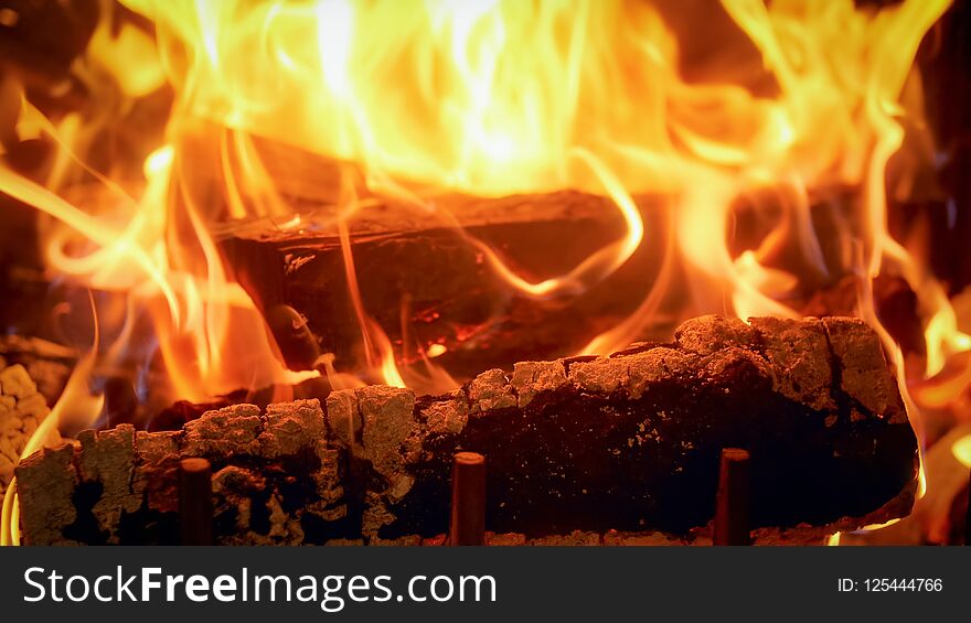 Closeup image of firepalce at house with burning logs