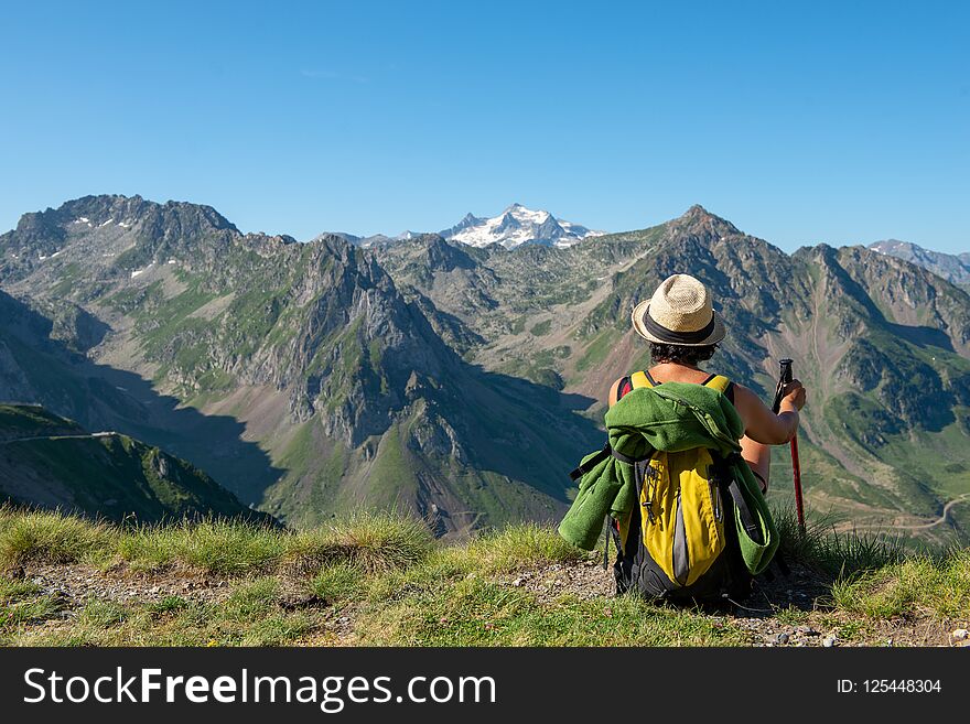 Woman hiker looking at the Pyrenees mountains