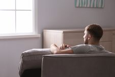 Depressed Young Man Sitting In Armchair Stock Image Depressed Young Man Sitting In Armchair Stock Image