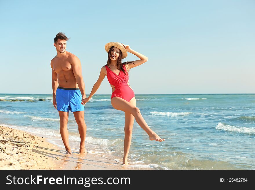 Happy Young Couple Having Fun At Beach