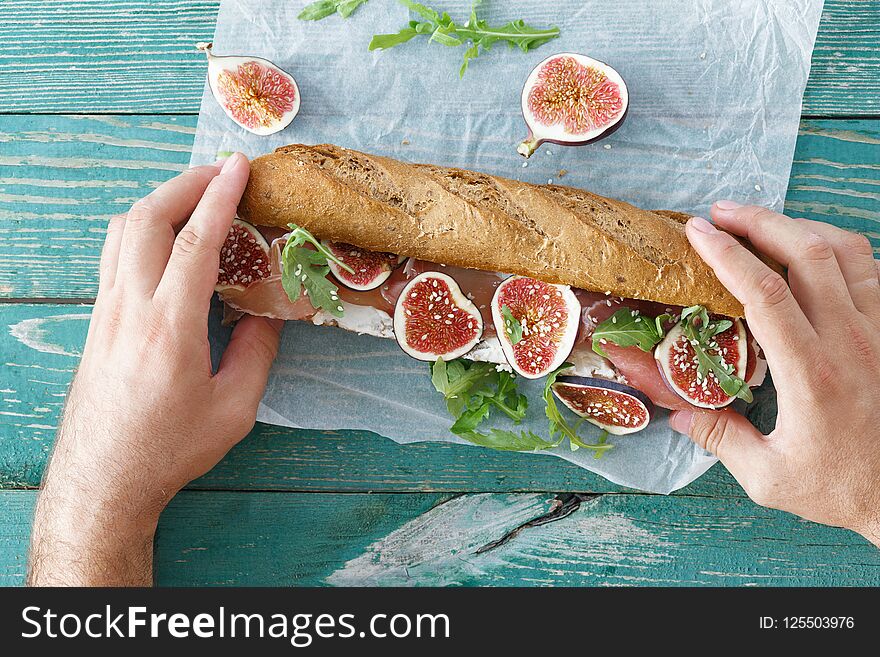 Outdoor Man Eating Sandwich Prosciutto Mascarpone Cheese Figs To