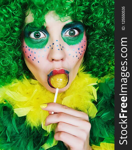 Close up of a face of a girl with creative visage with lollipopr