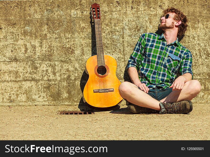 Young Bearded Hipster Man With Guitar Outdoor