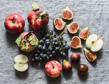 Seasonal Autumn Fruits - Apples, Grapes, Figs On A Gray Background, Top View. Royalty Free Stock Photography Seasonal Autumn Fruits - Apples, Grapes, Figs On A Gray Background, Top View. Royalty Free Stock Photography