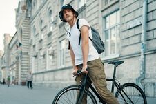 A Man Riding A Bike In An Old European City Outdoors Stock Photo