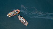 Fishing Boats And Oil Spill Royalty Free Stock Images