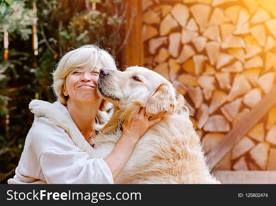 Pretty Blonde Woman Playing With Her Dog Golden Retriever