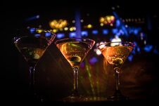 Several Glasses Of Famous Cocktail Martini, Shot At A Bar With Dark Toned Foggy Background And Disco Lights. Club Drink Concept Stock Photography