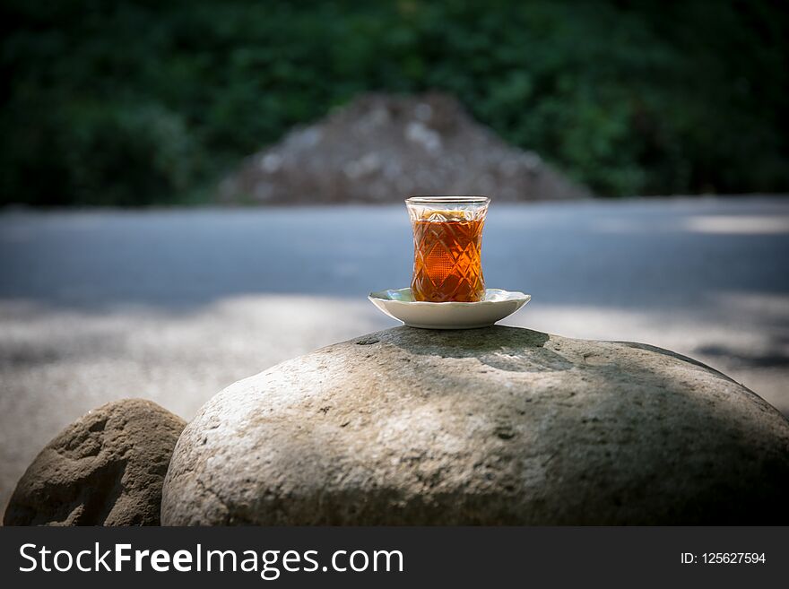 Eastern Black Tea In Glass On A Eastern Carpet. Eastern Tea Concept. Armudu Traditional Cup. Sunset Background. Selective Focus