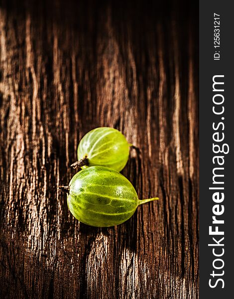 Ripe Gooseberries On Vintage Wooden Board