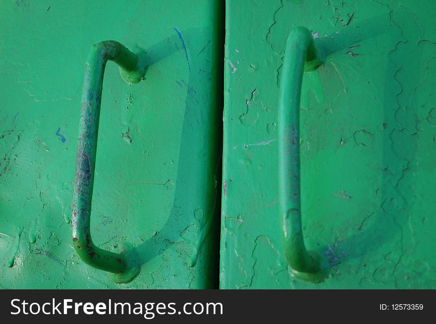 Green locked hand grips on a door
