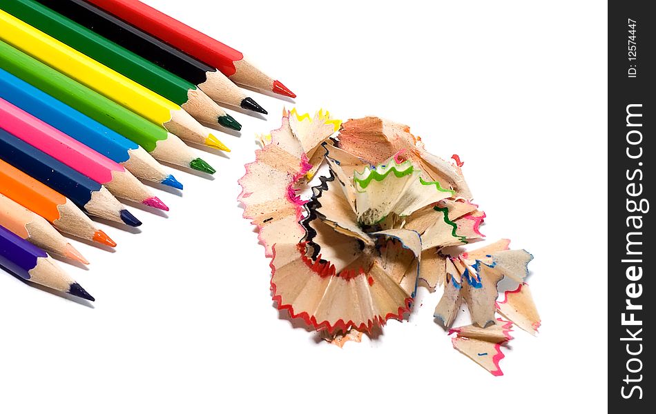 Sharpened colored pencils with the chips on a white background. Sharpened colored pencils with the chips on a white background