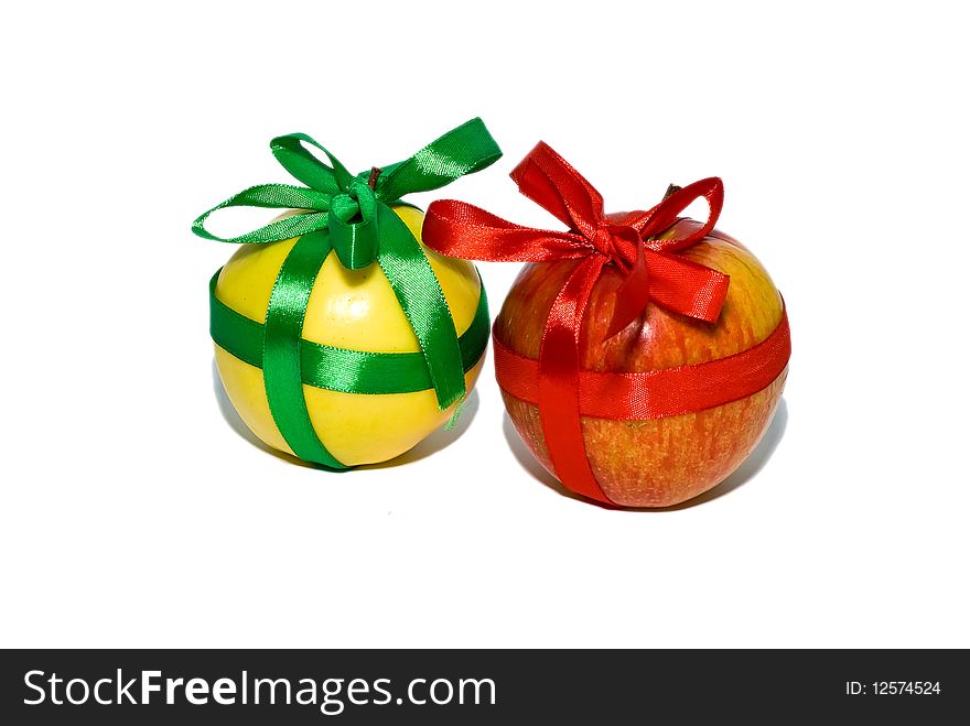 Couple of red and yellow apples with a gift bows on a white background